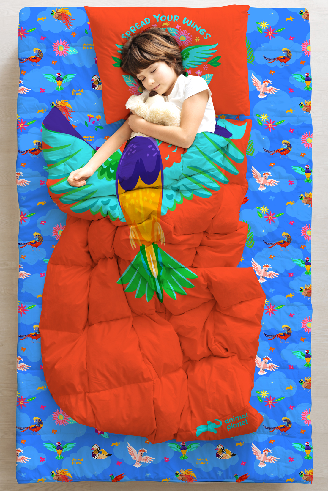 Girl in sleeping back emblazoned with large illustrated bird.